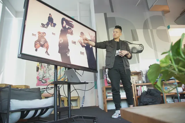 A guest pointing at a big screen during a workshop.
